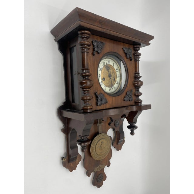 a wall clock *Antique wall clock regulator *richly decorated *with pendulum *mechanical clockwork *with gong *according to...