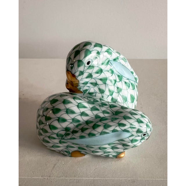 A charming hand-painted porcelain bunny couple by Herend, decorated in Herend’s iconic green fishnet pattern with delicate...