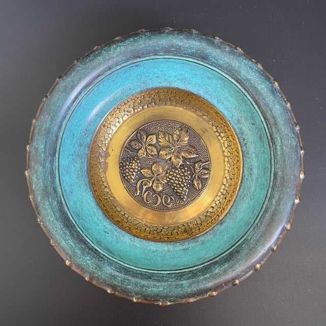 A vintage Oppenheim brass candy fruit bowl, featuring a rich verdigris enamel finish and a hammered repoussé design of...