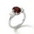 This exquisite ring showcases a striking Garnet gemstone at its center, celebrated for its deep red hue and captivating...
