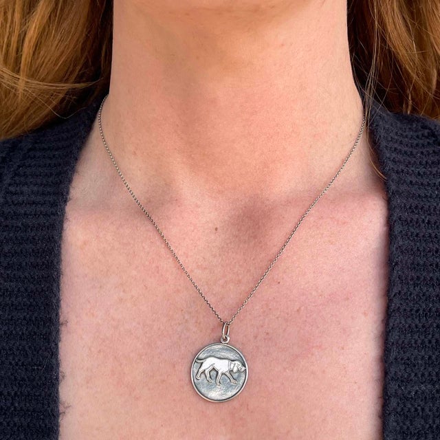 Step into the elegance of the Victorian era with this charming round silver watch fob, a delightful pendant that captures...