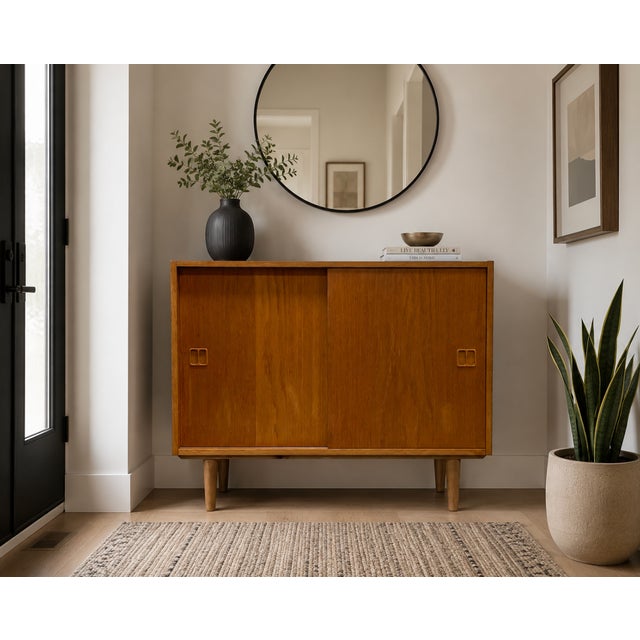 Danish Mid Century Modern Oak Jr. Credenza / Storage Cabinet, c. 1960's. This piece is highlighted by some incredible...