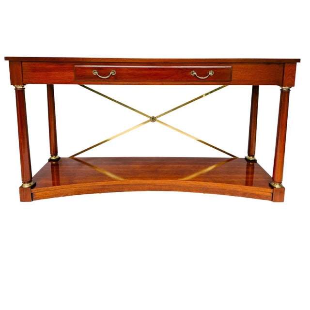 A stately console table is from the Medallion Collection by Ethan Allen in a Neoclassical / Federal / Regency Revival...