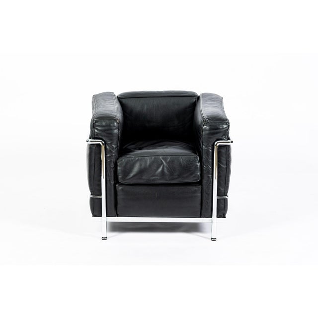 This authentic LC2 Petit Modele black leather armchair originally designed by Le Corbusier, Charlotte Perriand and Pierre...