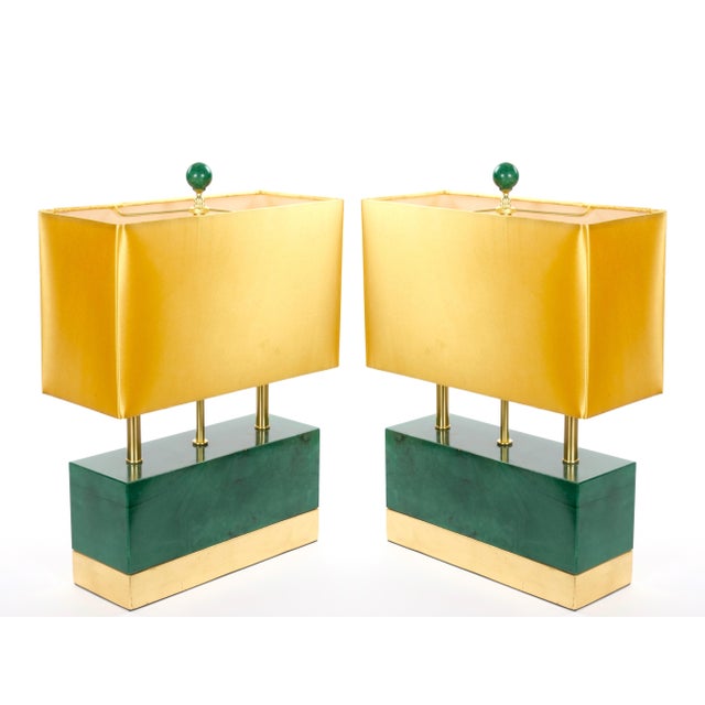 A striking pair of Italian mid-century modern table lamps in the Art Deco style, crafted in Italy during the late 20th...