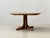 An elegant extendable dining table with a clean, scandinavian design. The oval tabletop is finished in warm teak veneer,...
