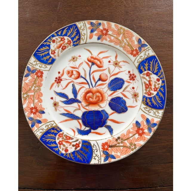 Set of 12 Imari-style porcelain dinner plates from Andrea by Sadek. The plates are each hand painted in cobalt blue, red-...