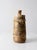 1970s handmade studio pottery jar featuring a tall cylindrical form, sculptural lid, and richly variegated earth-tone...