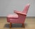 The chair features a beautifully sculpted silhouette with a high gently curved backrest, distinctive sweeping armrests and...