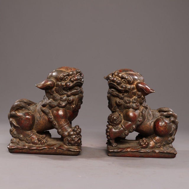 A pair of handcrafted Chinese wealth lions (fortune/guardian lions) cast in solid copper and finished in mottled gold with...