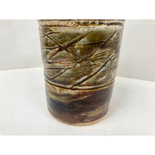 A well crafted Studio Pottery Vase with primitive incised lines in a central band with a Diamond pattern. With a strong...