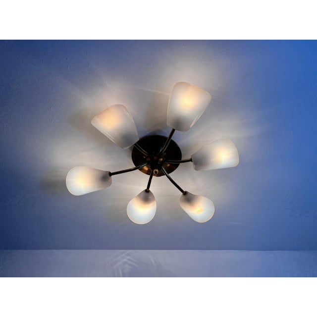 This Italian Sputnik ceiling lamp from the 1950s is a captivating example of mid-century modern design in the style of...