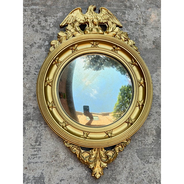 Striking vintage Federal-style convex wall mirror featuring a spread-wing eagle crest, dimensional stars, and ornate...