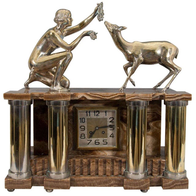 Amazing glorious solid French Art Deco gilt bronze and onyx clock decorated with four column supports framing the square...