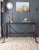 A console table designed with faux leather bridle straps in the manner of Jacques Adnet for Hermes. The heavy iron frame...
