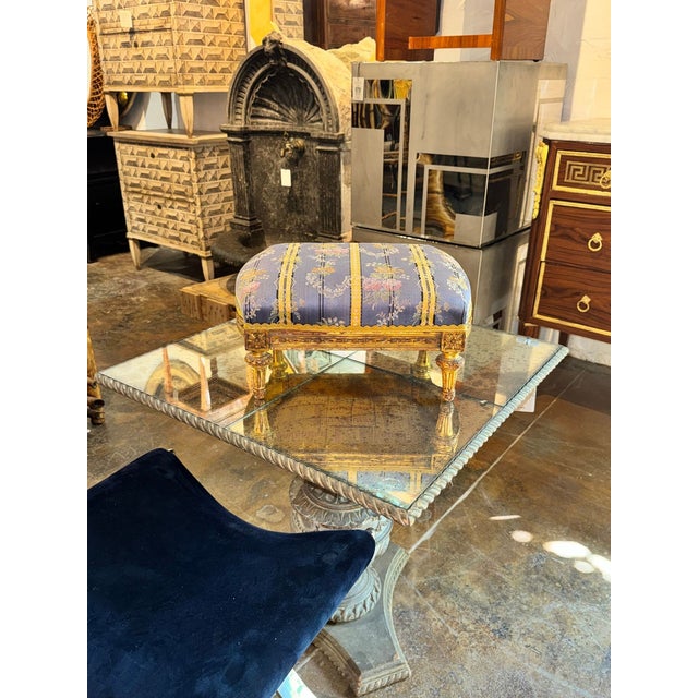 Indulge in luxury with this stunning French Louis XVI Giltwood Ottoman. This elegant piece adds a touch of sophistication...