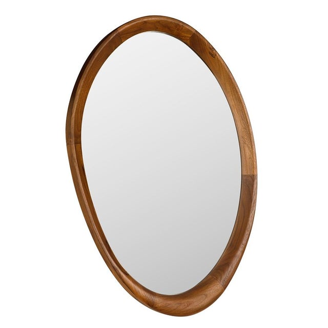 This asymmetrical oval mirror features a teak frame with natural grain patterns. Its organic shape and warm tones evoke a...