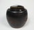 Mid 20th century brown glaze lidded pottery storage jar. The lid is in two parts and may not be the original lids as the...
