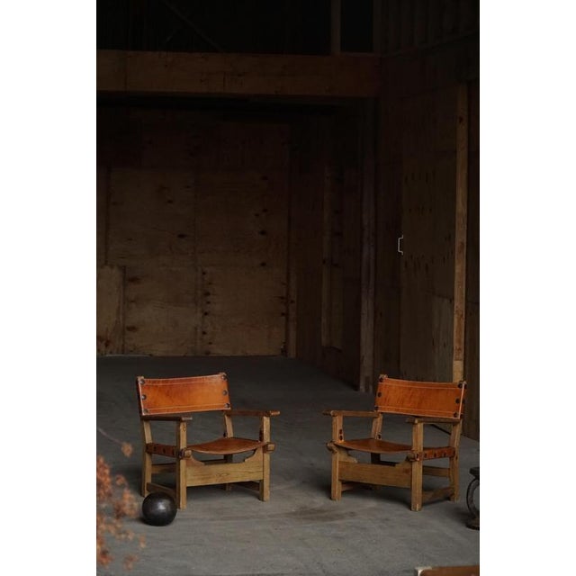 A beautiful pair of Brutalist armchairs / huntingchairs crafted in Spain during the 1960s, combining architectural form...