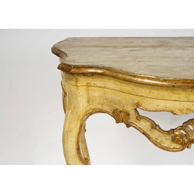 18th century fine Venetian Rococo Gilt and yellow painted console table. The Serpentine top over a pierced apron centered...