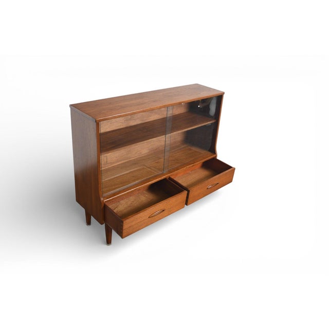 This Narrow Teak Curio Cabinet brings refined style and smart storage together in a compact frame. The elegant teak finish...