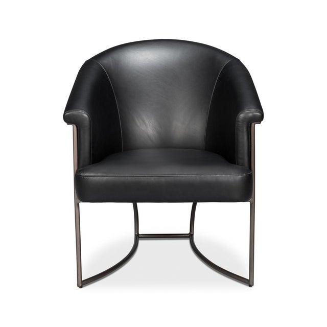 Upholstered in premium full-grain leather in onyx black, this chair exudes sophistication and timeless style. The curved...