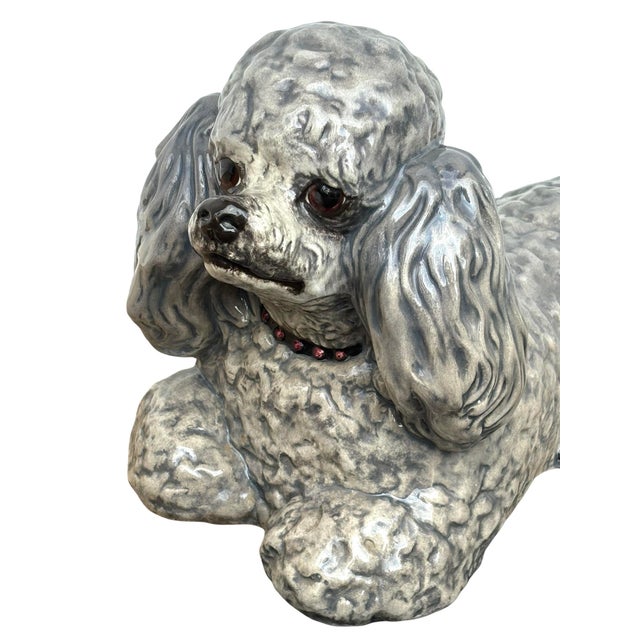Vintage 1970s grey life size poodle statue with ruby red collar.