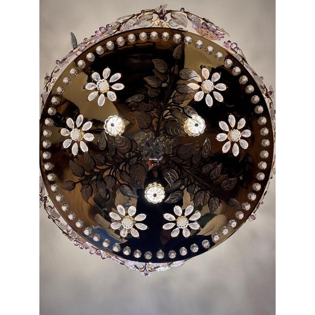 A breathtaking six lights chandelier with wonderful coloured crystals petals and leaves on scrolling gilded metal...