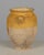 An earthenware confit pot from the Southwest of France with traditional yellow glaze. Minor losses to glaze. Bottom is...