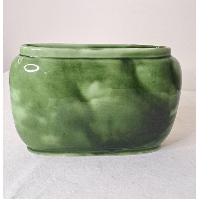 A striking vintage mid-century modern art pottery planter by Royal Hickman, marked with his name and the number 516. Known...