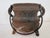 This antique cast iron three-leg cauldron is a striking example of 19th-century utilitarian cookware, now highly coveted...