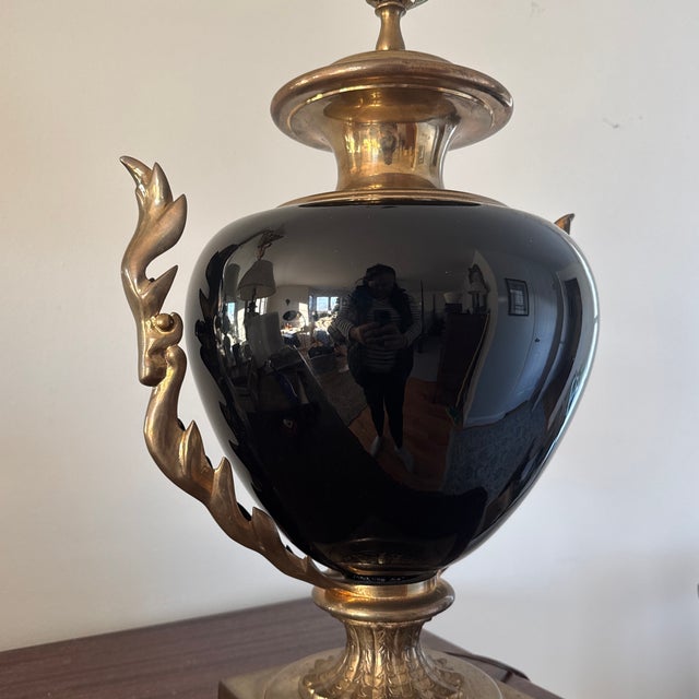 Listing is for a vintage Chapman black table lamp in the French Empire style. I believe the black body is patinated metal...