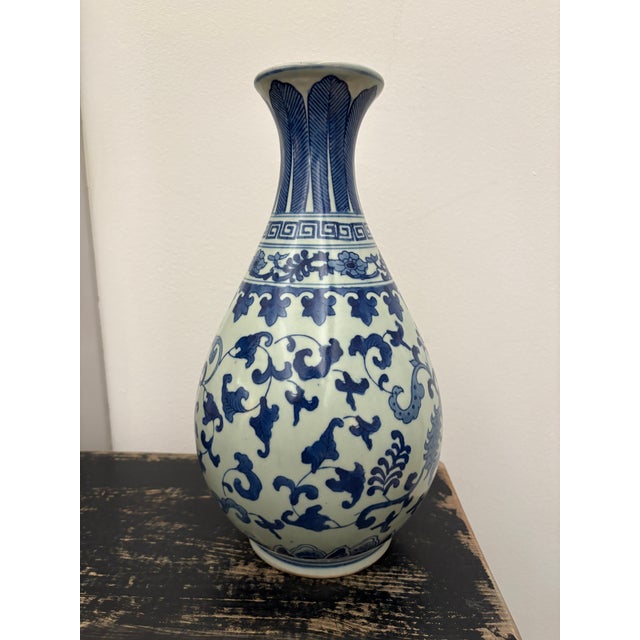 Lovely traditional blue and white vase featuring a bird in its design. Elegant form for any elevated space!