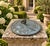 A classic vintage iron garden sundial inspired by traditional English estate landscapes, reading "Grow old along with me....