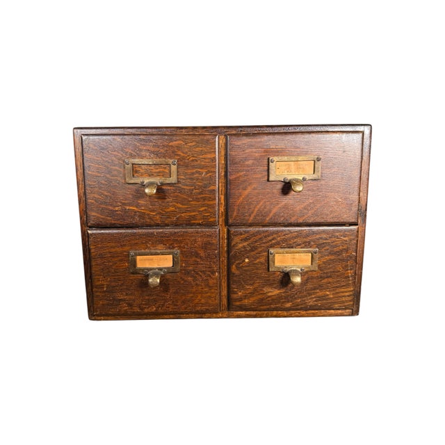 An incredibly rare vintage solid wood desktop library cabinet with four drawers, including all of the original brass...