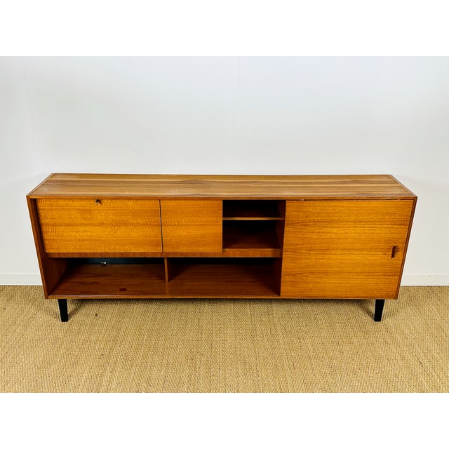 Vintage Scandinavian teak sideboard dating from the 1960s. Features one door, one hinged door, and one sliding door. Ample...
