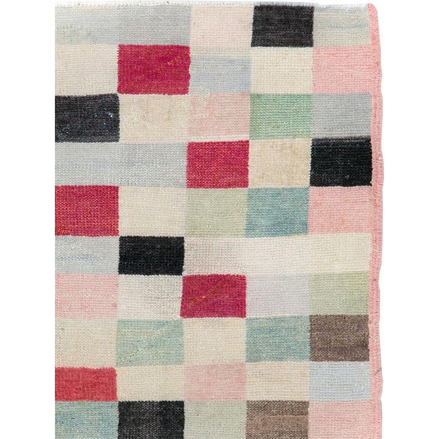 This mid-20th-century Turkish Art Deco accent rug presents a lively checkerboard composition built from rectangular blocks...
