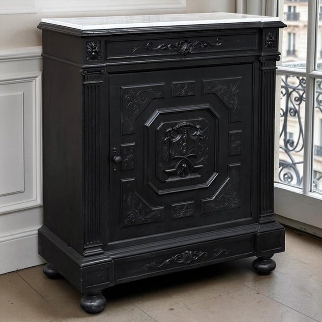 A 19th century French Napoleon III period ebonized cabinet crowned with a pure white Carrara marble top. Strong...