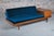 Mid Century teak daybed with teal colour velvet cushions, circa 1960s. The side table with magazine compartment flips up...