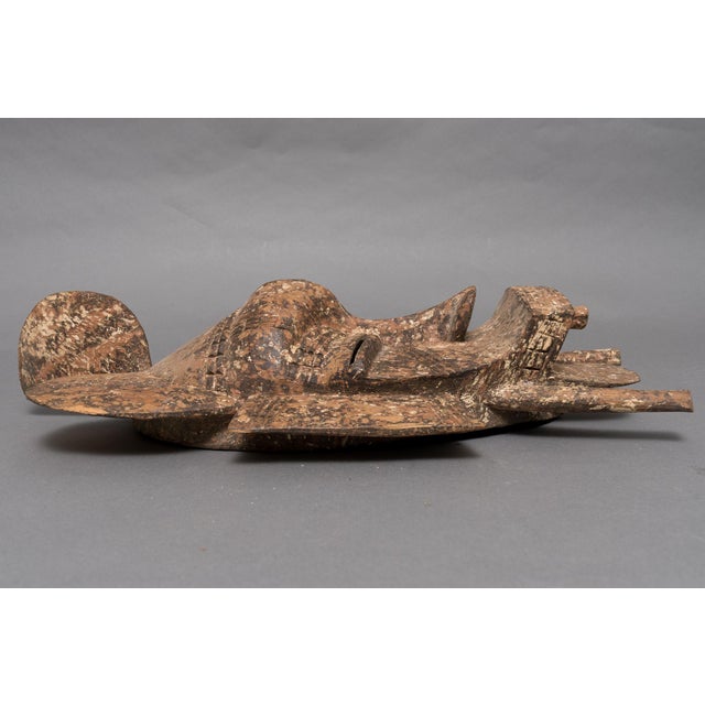 An imposing Senufo Kpelie mask from the Côte d'Ivoire (Ivory Coast) with an elaborate crest wing-like ear projections, and...