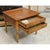 This piece features a warm, polished wood finish that highlights its natural grain and traditional character. Two front...