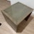 Solid wood end / side table with inset glass top by Kravet. Wooden table in an oyster grey finish. The glass top allows...