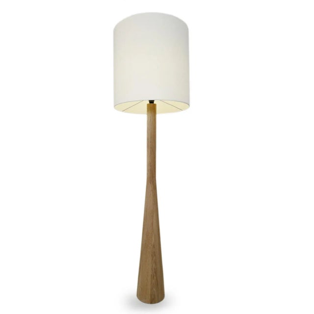 Modern raw oak floor lamp with white linen shade. Each may vary in natural oak wood tones / grain. Base measures 7.25" x...