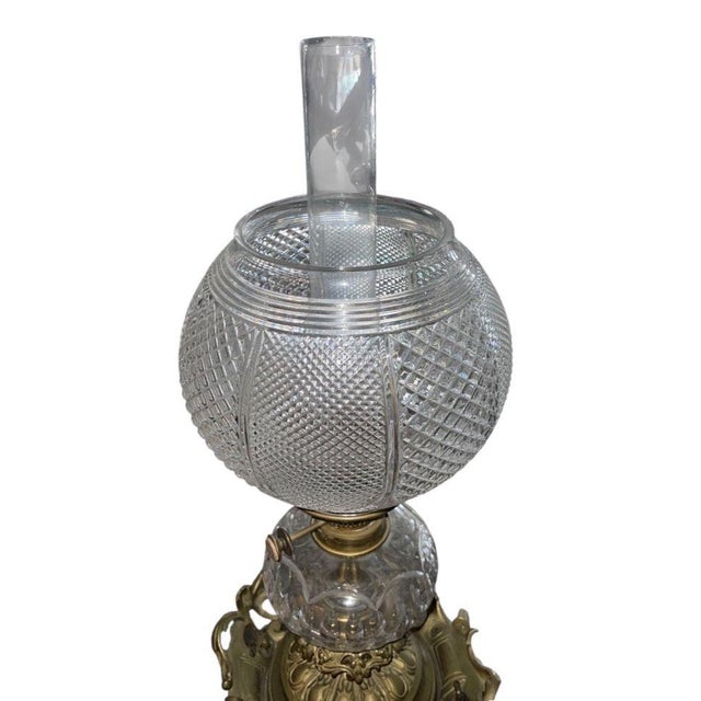 A striking 19th-century Italian oil lamp, later electrified, featuring an elaborate cast bronze base richly adorned with...