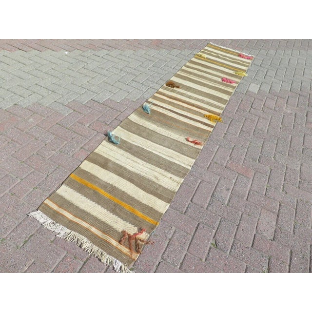 This beautiful, traditional vintage, flatweaved Turkish runner is approximately 60 years old. It is handmade of very fine...