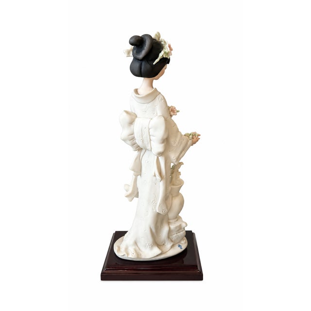 Elegant vintage porcelain figurine by Giuseppe Armani for Florence, titled “Oriental Lady With Vase”, model 0404S, and...