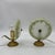 This pair of vintage table lamps features a crafted and decorated brass base, characterized by an elegant and ornamental...