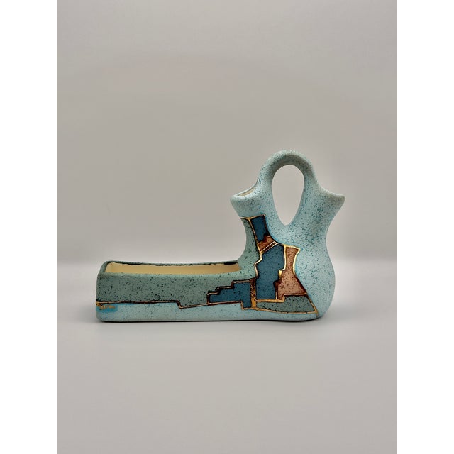 A striking piece of Southwestern-inspired vintage pottery that brings both artistry and function to your home or office....