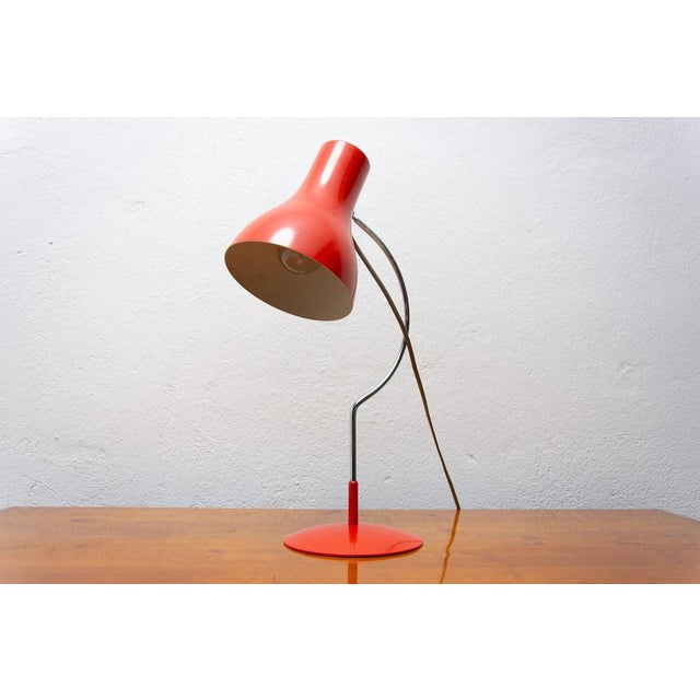 This midcentury table lamp was designed by Josef Hurka for Napako. It features a chrome arched construction to which a red...
