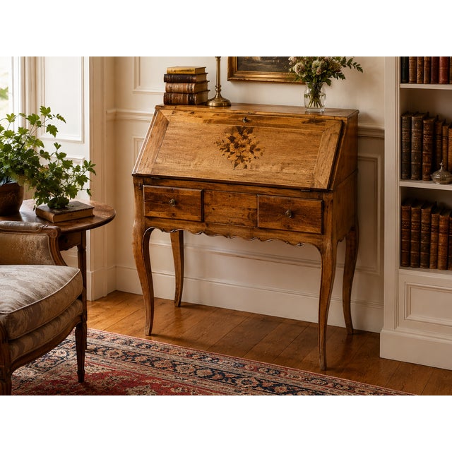 This charming French slant-front secretary immediately captivates with its balanced proportions, the gentle curves of its...